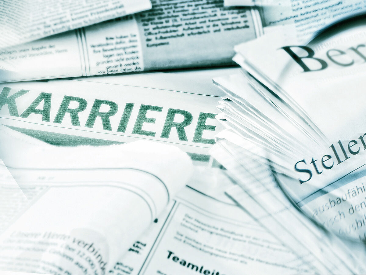 Job offers with magnifying glass and application folder