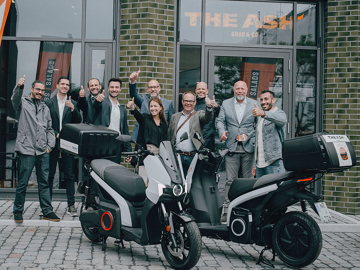 Mitarbeiter der Apeiron GmbH und von Löhr Automobile Neuwied hinter SEAT MÓ Rollern 