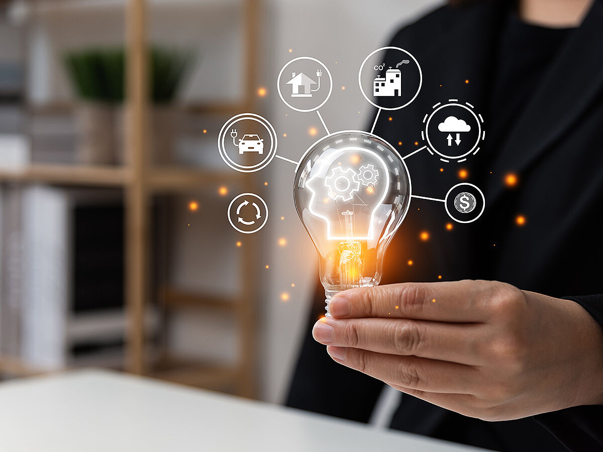 Businessman hand holding light bulb with climate change concept, virtual screen of power green energy and sustainable, , carbon credit, net zero, zero emission, environmental, social, governance, ESG.