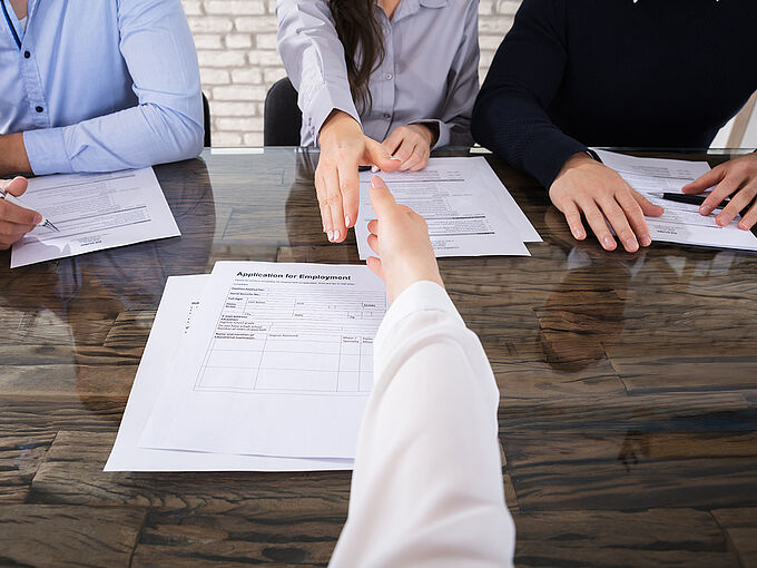 Close-up Of An Applicant Shaking Hand With Corporate Recruitment Officers In Office